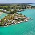 Aerial view of Paradise Cove Boutique Hotel in Cap Malheureux on a turquoise lagoon with tropical islets