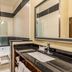 Fairfield Inn & Suites by Marriott Alamogordo bathroom with soaking tub, vanity, and glass shower door