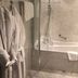 Boutique Hotel Slenaker Vallei bathroom with walk-in shower, bathtub and plush robes in Slenaken