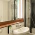 Campanile Nature - Sannois Ermont bathroom with sink, mirror, shower, and black-and-white wall mural in Sannois