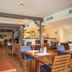 Fletcher Hotel-Restaurant De Klepperman in Hoevelaken restaurant with wooden tables and blue chairs