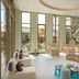 Titanic Deluxe Lara in Antalya kids' play lounge with large windows, mural wall and soft seating