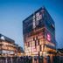 Ruizhao Hotel (Beijing Guomao Branch) in Beijing, modern glass hotel exterior at dusk with crowds outside