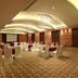 Fortune Select Sg Highway, Ahmedabad banquet hall with round tables, white chair covers and curved ceiling lights