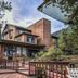 The Historic Crags Lodge in Estes Park with rustic lodge exterior, mountain setting, and outdoor patio seating