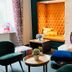 Hotel Villa Carlton - Adults Only Salzburg lounge with velvet chairs, built-in seating, brick fireplace and books