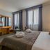 Unaway Hotel Occhiobello A-13 guest room in Rovigo with double bed, TV, desk and curtains