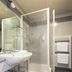 Park Hotel Abbadia bathroom with walk-in shower, sink, mirror and towel rack in Abbadia Lariana