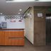 Hotel Daya Continental reception desk in New Delhi with glass entrance doors and wall clocks