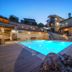 Asion Lithos in Kato Asites: stone hotel courtyard with illuminated outdoor pool and wooden deck