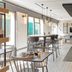 Campanile Nature - Sannois Ermont breakfast area with bar counter, high tables and seating in Sannois