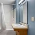 Extended Stay America Select Suites - Panama City - Callaway bathroom with tub, shower curtain, sink and mirror