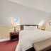 Chateau de Vie in Calistoga guest room with queen bed, skylight, bench, and mirrored closet
