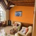 Hosteria Ailen in Ushuaia lounge with vaulted wooden ceiling, large window, sofas and seating area