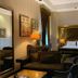 Sultan Inn Boutique Hotel in Baku guest room with king bed, seating area and ornate headboard