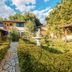 Hotel Serra Everest in Nova Friburgo: landscaped garden courtyard with fountain and stone path