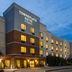 TownePlace Suites by Marriott Williamsport exterior at dusk with lit windows and main entrance