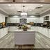 Homewood Suites by Hilton Burlington kitchen with white cabinets, central island and pendant light