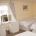 The Buck Inn, Richmond: guest room with three single beds, vanity desk, and chandelier