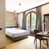 Antico Borgo di Sutri guest room with arched window, desk, and walk-in shower in Sutri