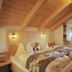 Appartement Sonnengarten in Ramsau am Dachstein bedroom with wooden ceiling, twin beds and window light