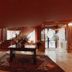 Hotel Fraga do Eume in Capela lobby with central table, rug, staircase and decorative floral arrangement