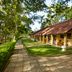 Habarana Village by Cinnamon in Habarana, bungalow-style hotel rooms along a leafy garden path