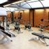 Hotel Estelar de La Feria Bogotá fitness room with exercise bikes, weights, and workout bench