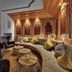 Königshof Hotel Resort in Oberstaufen lounge with curved seating, copper fire feature, and wood-paneled walls