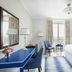 The Phoenicia Malta room in Valletta with blue desk, king bed and city view through tall windows