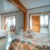 Keuhenua Hostal in Hanga Roa: colorful twin bedroom with floral bedding and mural wall