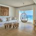 Santa Marina, a Luxury Collection Resort, Mykonos room with hanging chair and sea view over Ornos