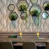 Leonardo Hotel & Residenz München dining area with geometric wall planters and a long table