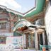 Power Park Accommodation in Kauhava, colorful rustic hotel exterior with entrance and carved wood details