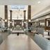 Hilton Garden Inn Dulles North in Ashburn lobby dining area with tables and skylight