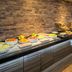 Breakfast buffet at Real Inn Perinorte in Tlalnepantla with fruit, pastries and drinks along a brick wall