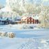 Järvsöbaden in Järvsö, snow-covered red and dark lodge buildings amid a winter landscape