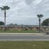 Prince of Wales Motel in Lake Wales, low-rise roadside motel with palm trees under cloudy skies