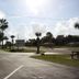Prince of Wales Motel in Lake Wales with palm-lined parking lot and roadside sign under a bright sky