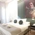 Les Monges Palace Boutique Alicante guest room with bed, desk, chair, and portrait wall art