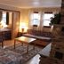 Nootka Lodge in Woodsville room with bed, sofa, coffee table, chair, fireplace and window view