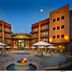Desert Diamond Casino Tucson courtyard with fire pit, pool, and balconies at dusk