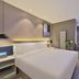 Orange Hotel Beijing Chaoyangmen Yabao Road Children's Hospital guest room with king bed and window seat in Beijing