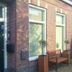 Bordine Guesthouse in Leeuwarden exterior with brick facade, windows, and a wooden bench by the entrance