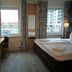 Hotel Near By in Laatzen guest room with twin bed, desk, and city view windows