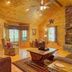 Paradise Hills, Winery Resort & Spa in Blairsville living room with stone fireplace and mountain view window
