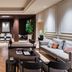 Worldhotel Cristoforo Colombo Milan lounge with seating, wood-paneled alcove, and herringbone floors