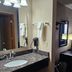 Super 8 by Wyndham Estherville guest room with vanity, dresser, desk, TV, and window