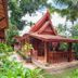 Royal Phawadee Village Patong villa amid tropical gardens, with Thai-style roof and wooden porch