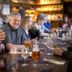 Kosta Lodge in Kosta: guests chatting at a restaurant table with drinks in a cozy lounge